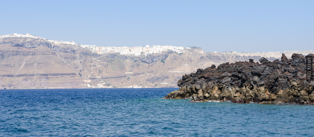 Solidified basaltic lava  Nea Kameni volcanic island  Santorini with Fira town  Greece  01